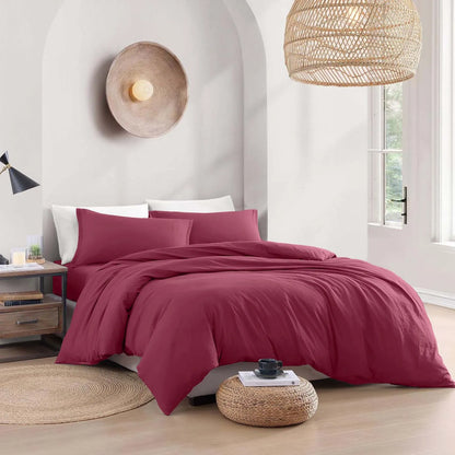 Bedroom with maroon bedding and wicker decor