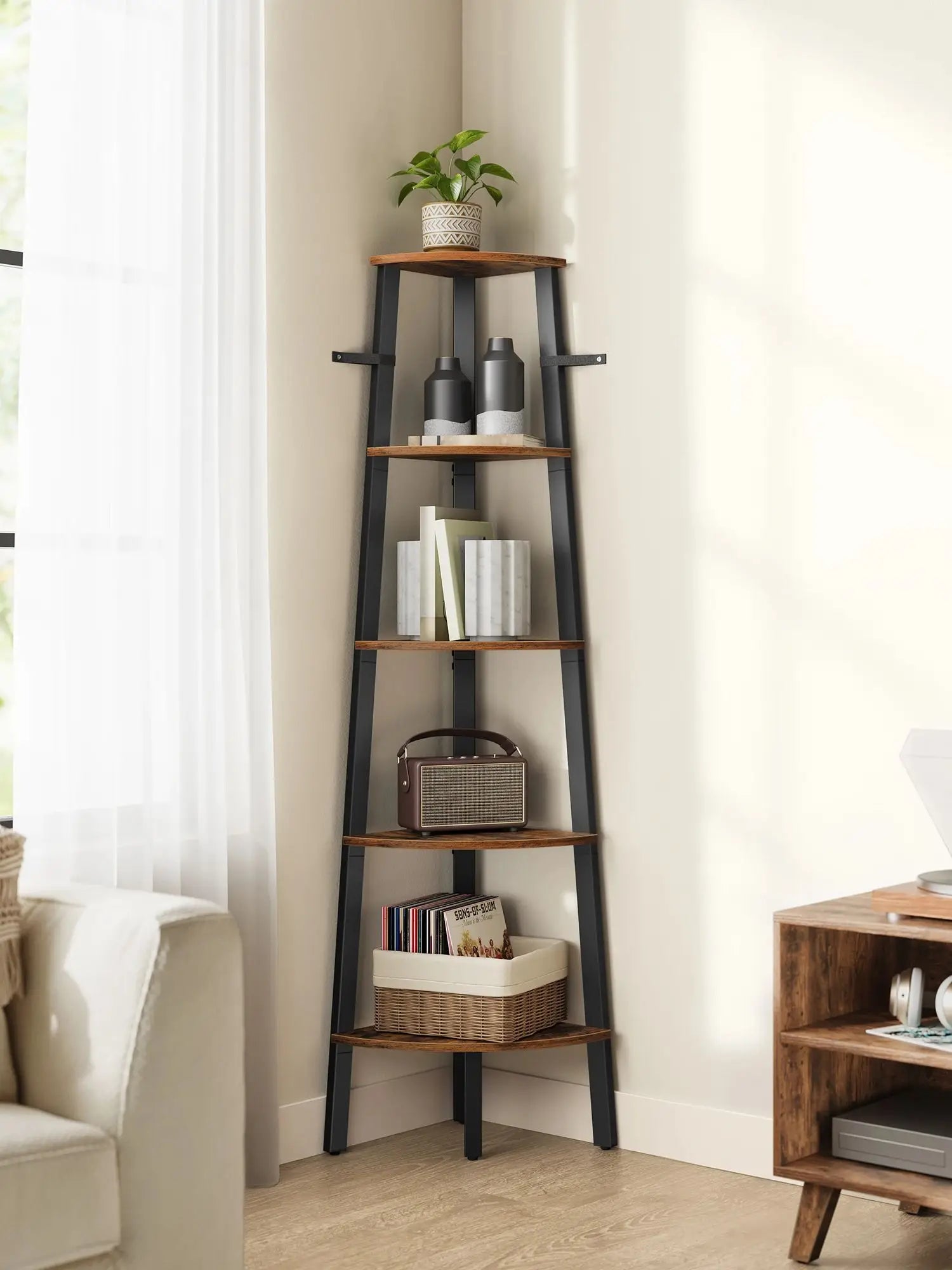 Tall corner ladder shelf with decorative items against a white wall.