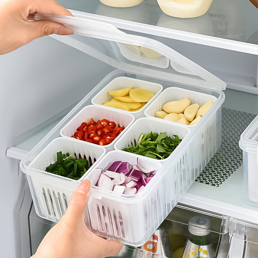 Transparent food storage container with compartments filled with chopped vegetables held by a hand in front of an open refrigerator.
