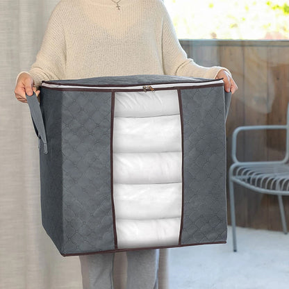 Person holding a large gray storage bag with a quilted white interior.
