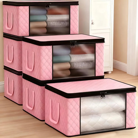 Set of pink storage boxes with quilted design on a wooden floor.