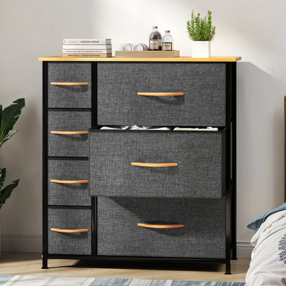 Gray dresser with wooden drawers in a room setting