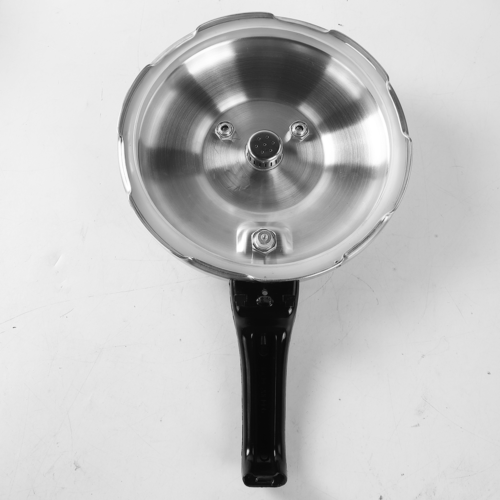 Metallic pressure cooker lid with black handle on a white background