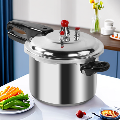 Stainless steel pressure cooker on a kitchen counter with vegetables and a bowl of food.