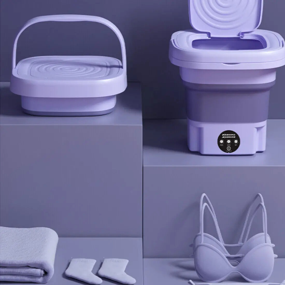 Collapsible purple washing machine with accessories on a gray background