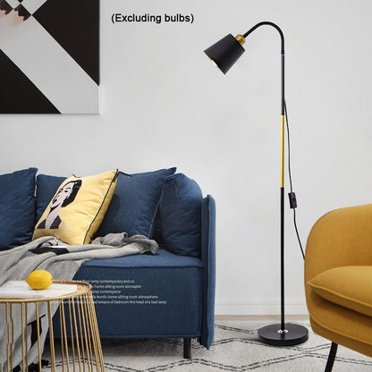 Modern living room with a blue sofa, yellow chair, and standing lamp.