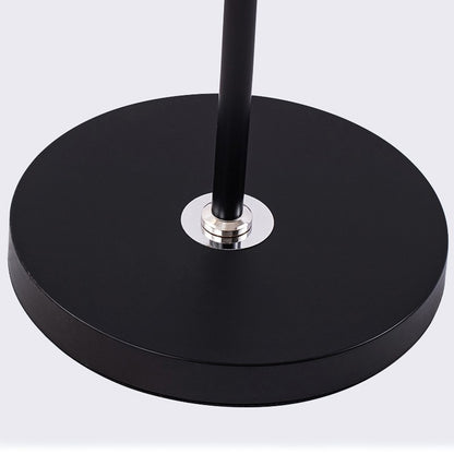 Black round base with a central metallic fixture on a light gray background