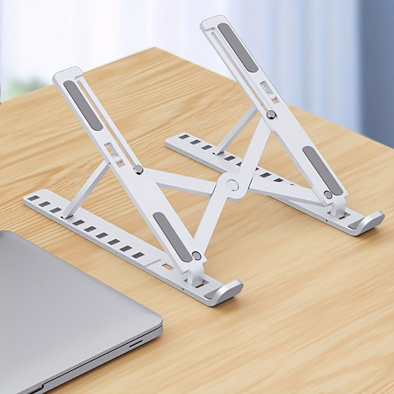 Foldable laptop stand on a wooden surface with a blurred background