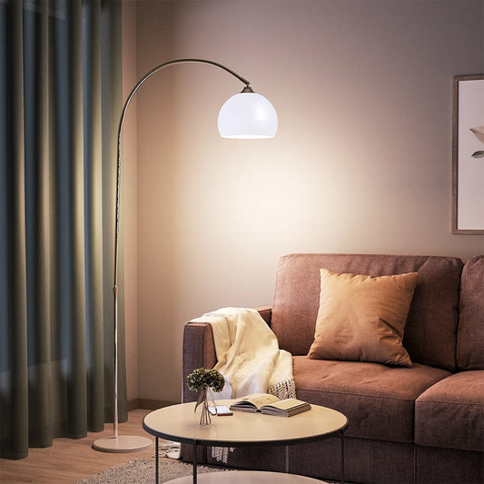 Modern living room with a brown sofa, floor lamp, and small table.