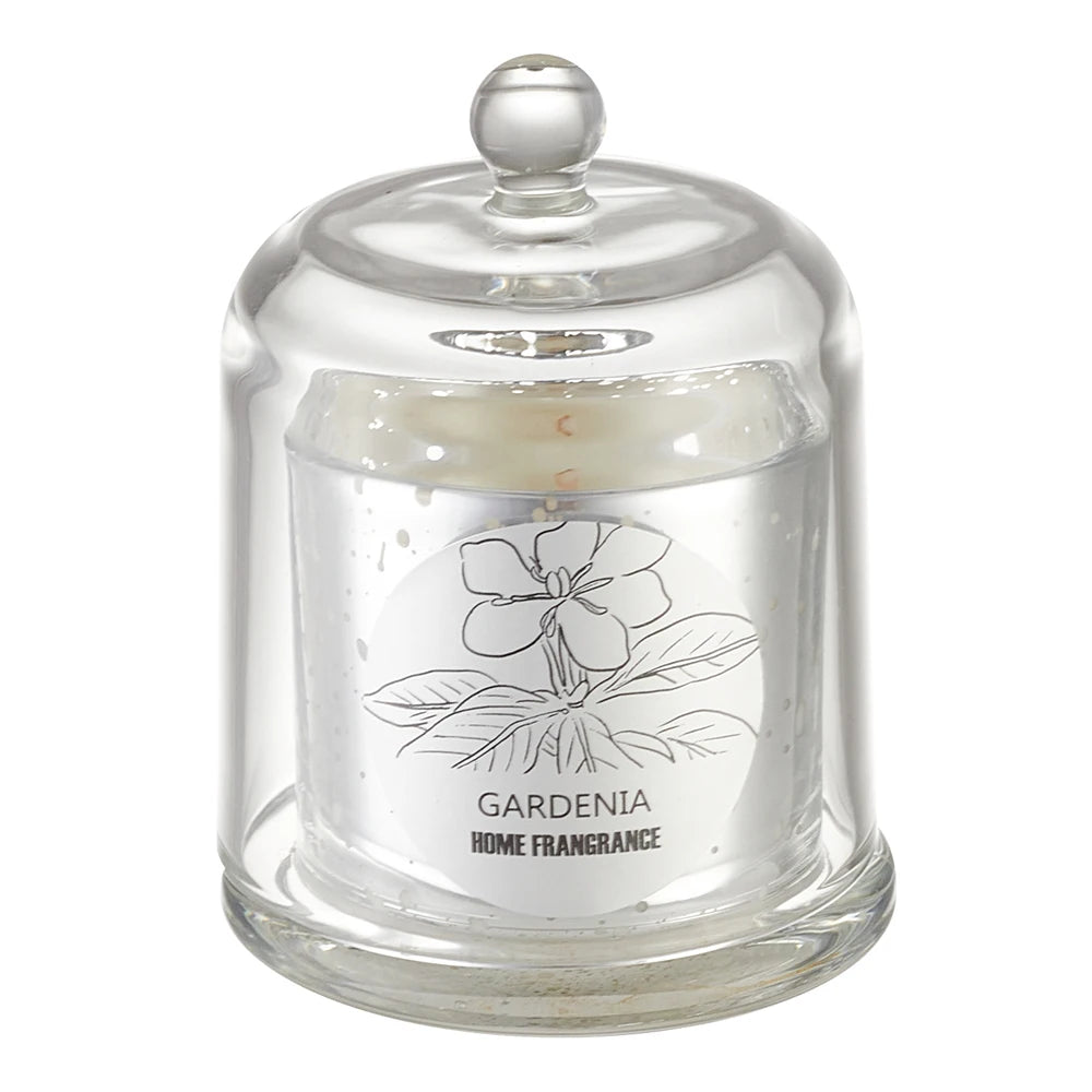Glass jar with a lid containing a Gardenia home fragrance candle on a white background