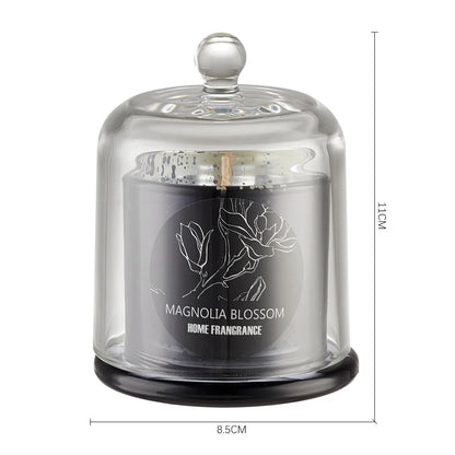 Glass dome candle with 'Magnolia Blossom Home Fragrance' label on a white background