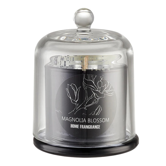 Candle in a glass dome with 'Magnolia Blossom' branding on a white background