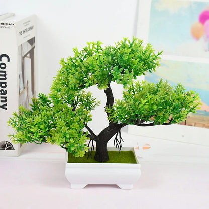 Artificial bonsai tree in a white pot on a light surface with a blurred background