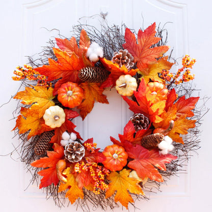Autumn wreath with leaves, pumpkins, and pinecones on a white door.