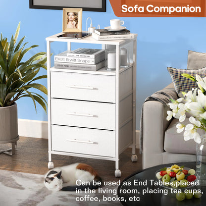 White side table with drawers in a living room setting, featuring a cat and a plant.