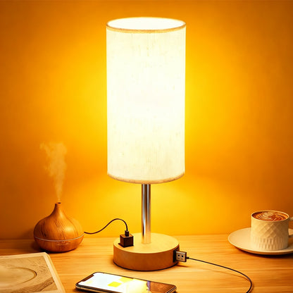 Table lamp with wooden base on a wooden surface with a yellow background