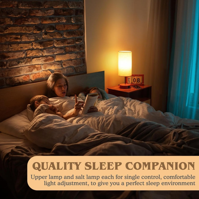 Woman reading a book to a child in bed with a nightstand lamp and salt lamp.