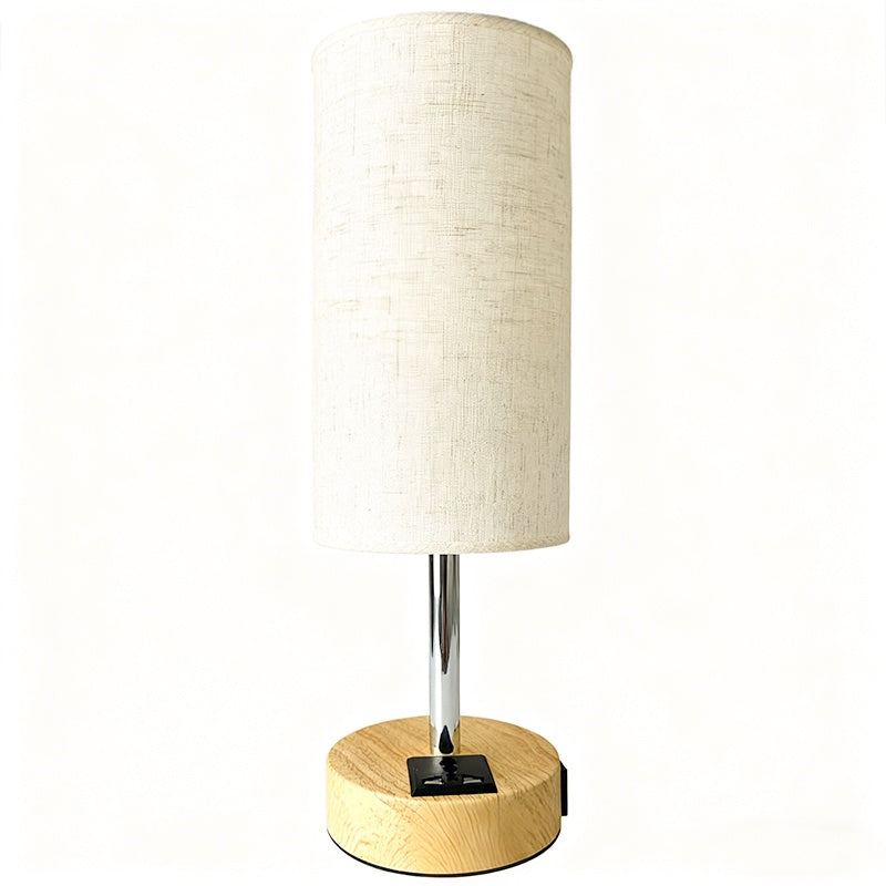 Table lamp with wooden base and beige fabric shade on a white background