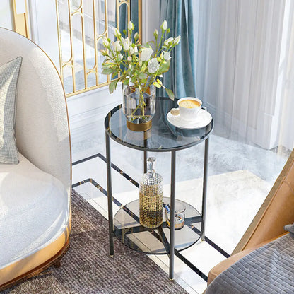 Small round glass table with decorative items in a modern living room.