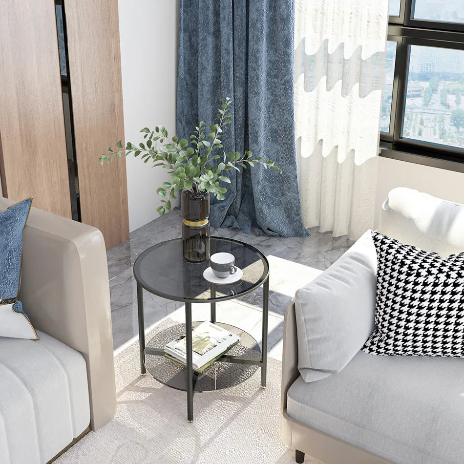 Modern living room with gray sofa, armchair, and round glass table.