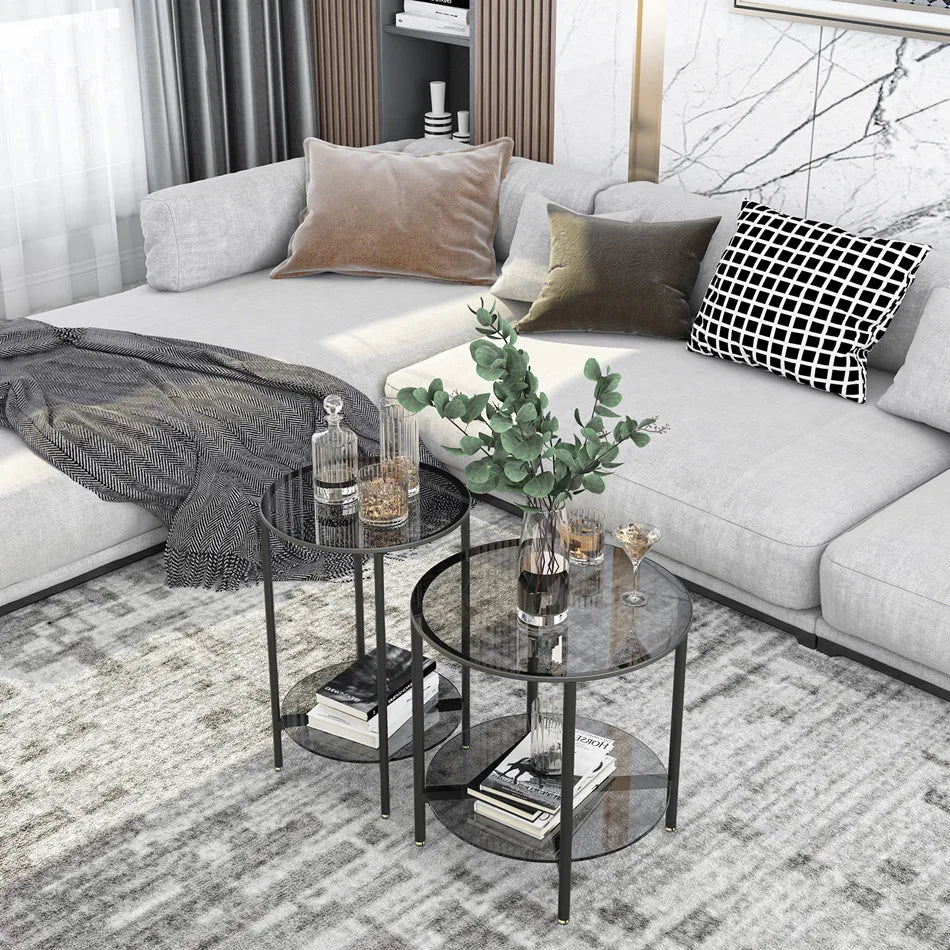 Modern living room with a gray sectional sofa, decorative pillows, and a coffee table with books and plants.