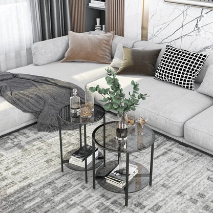 Modern living room with a gray sectional sofa, decorative pillows, and a coffee table with books and plants.