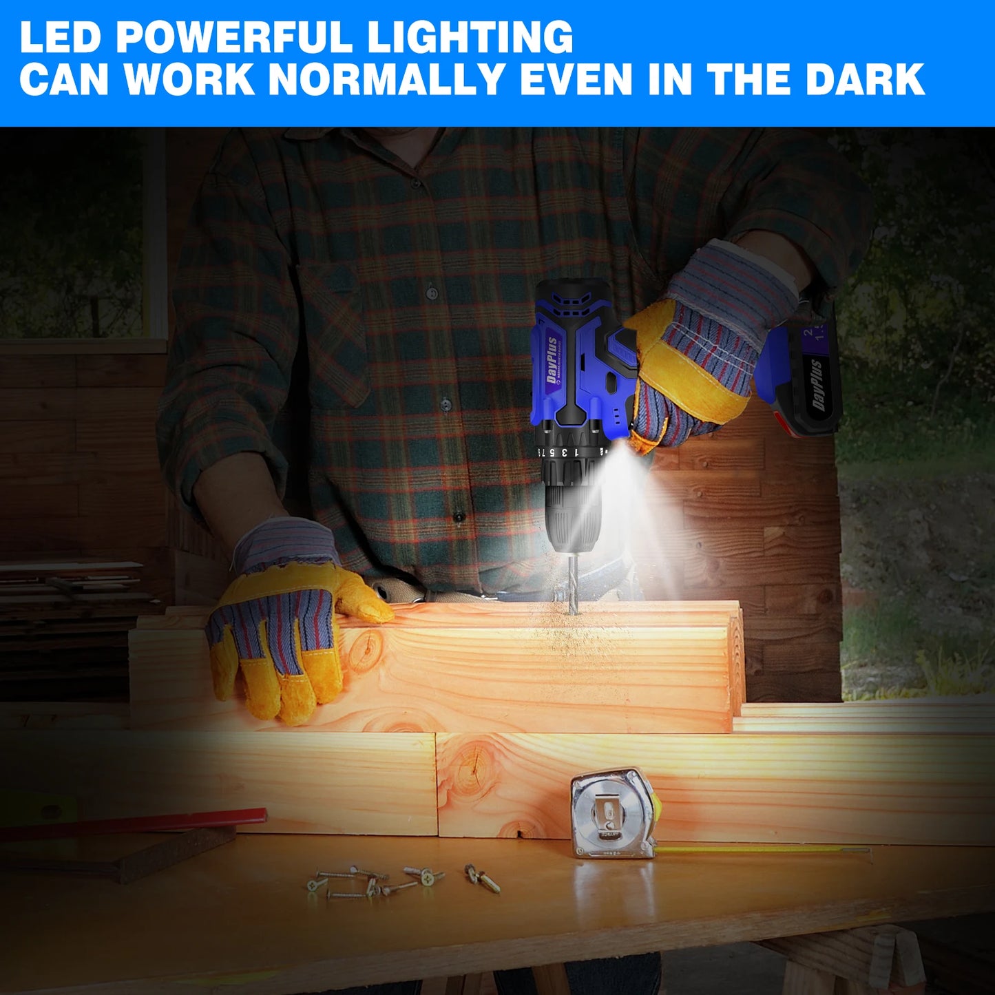 Person using a cordless drill with LED lighting on a wooden surface at night.