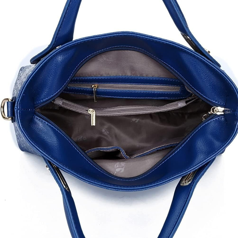 Blue handbag with open interior showing zippers on a white background