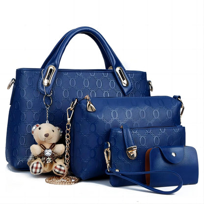Set of blue handbags with a teddy bear charm on a white background