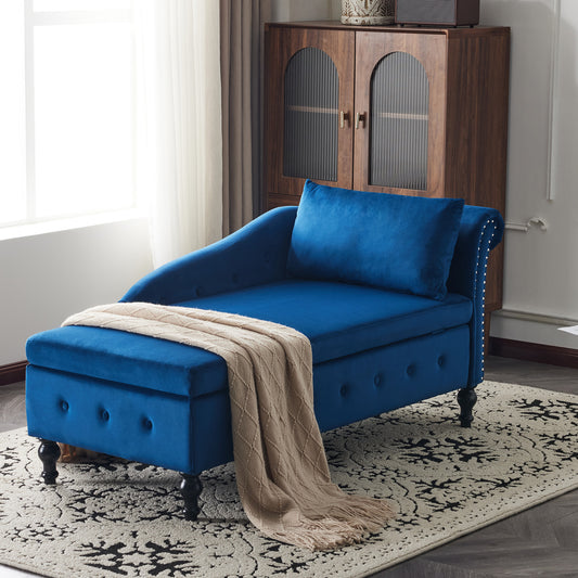Blue chaise lounge with a beige blanket on a patterned rug in a room with a wooden cabinet.