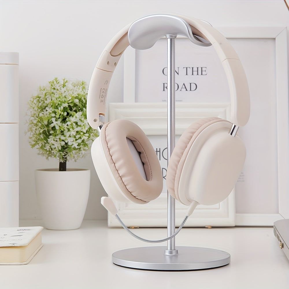 Beige headphones on a stand with a white background