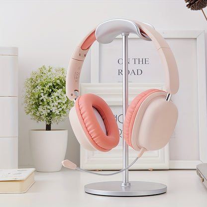 Pink headphones on a stand with a minimal background