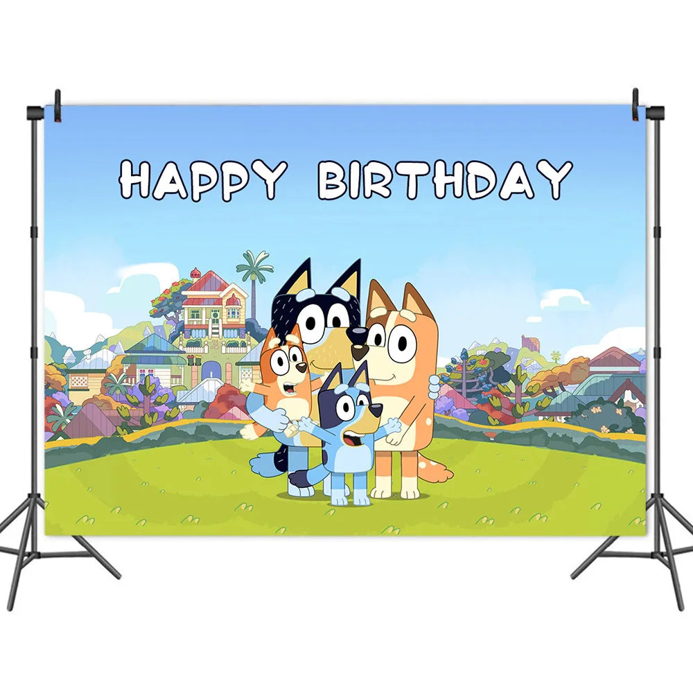 A large birthday backdrop banner displayed on a black studio support stand. The banner features a colorful cartoon scene with three dogs standing together on a green lawn, with houses and trees in the background under a blue sky.