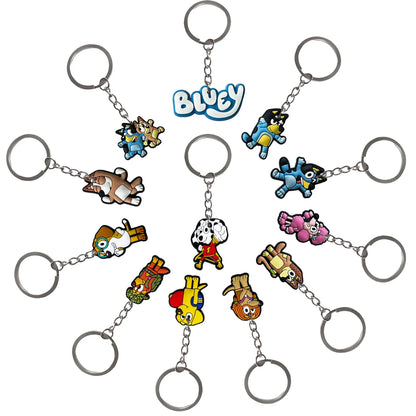 A set of small keychains arranged in a circle on a white background. Each keychain has a silver metal key ring and chain with a colorful cartoon dog charm.