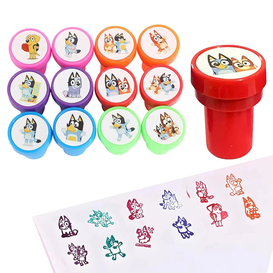 A set of colorful circular animal-themed stamp pads with a red cylindrical stamp shown beside them, plus a sheet of sample stamped animal and snowflake designs on a white background.