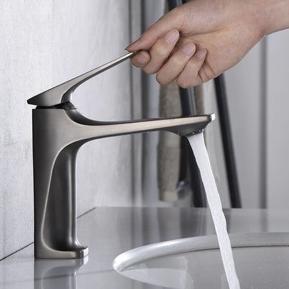 Modern faucet with water flowing, hand turning the handle