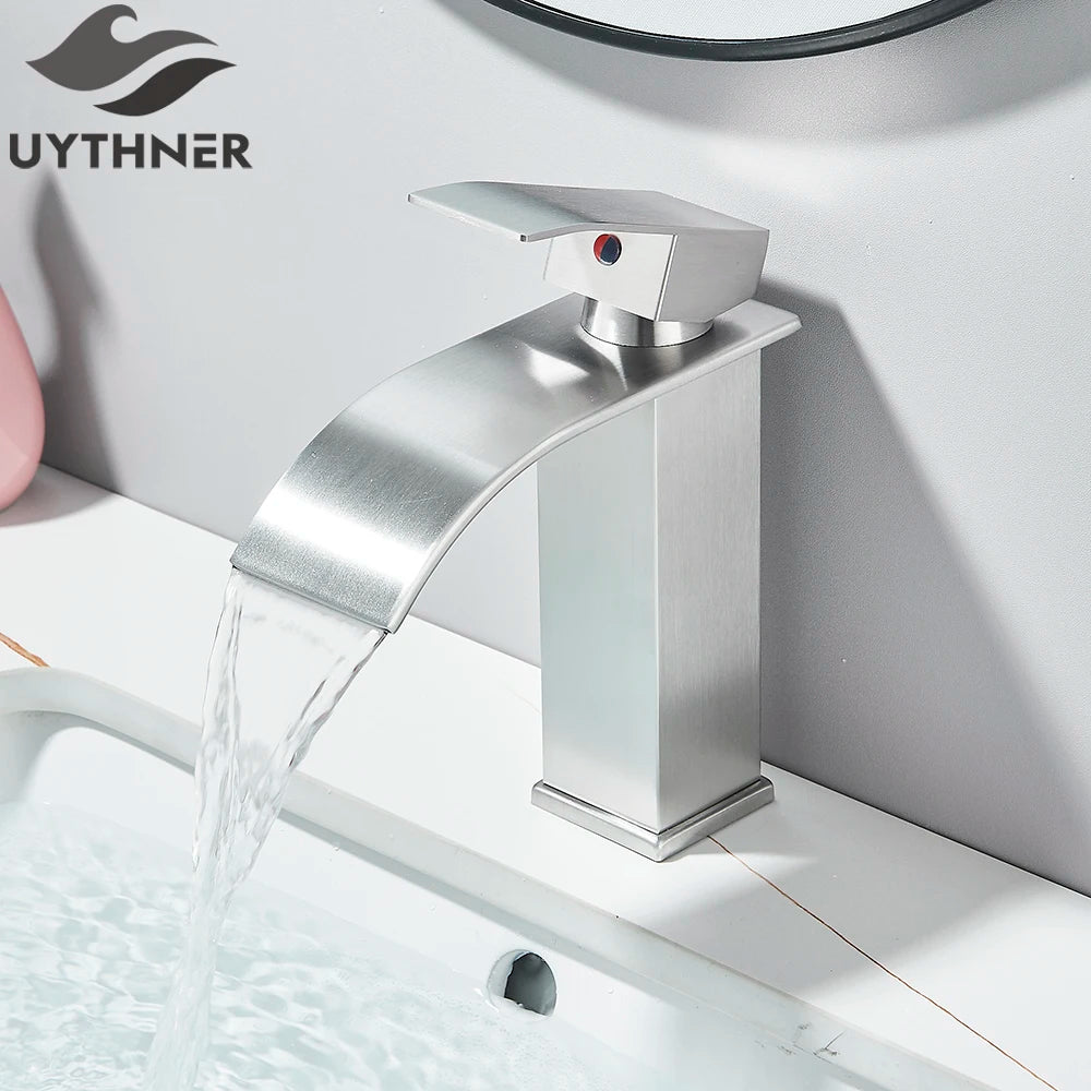 Silver faucet with water flowing into a sink, branded 'UYTHNER'.