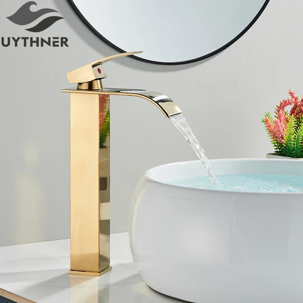 Gold faucet with water flowing into a white basin in a bathroom setting, featuring the Uythner brand.