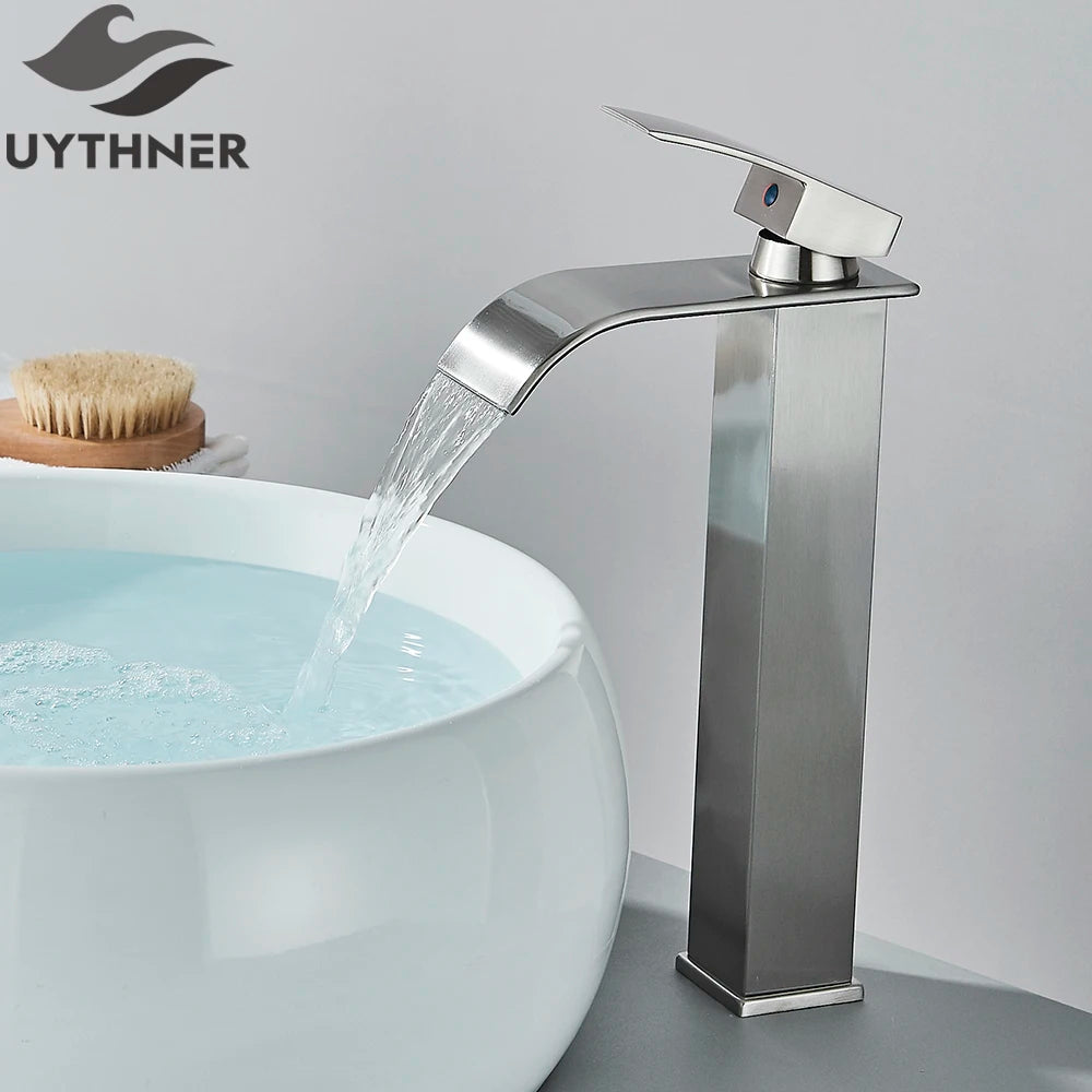 Chrome waterfall faucet with running water into a white sink, branded 'UYTHNER'.