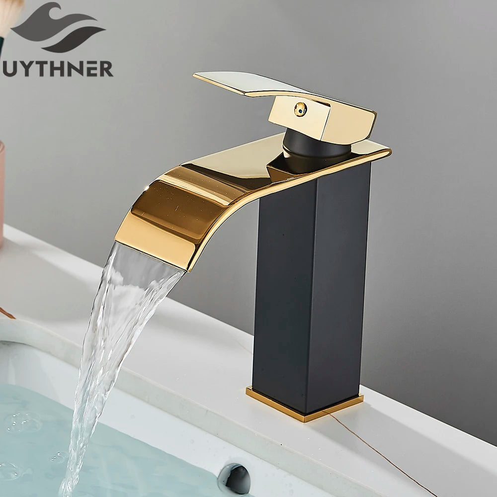 Gold and black faucet with water flowing, branded 'UYTHNER'.