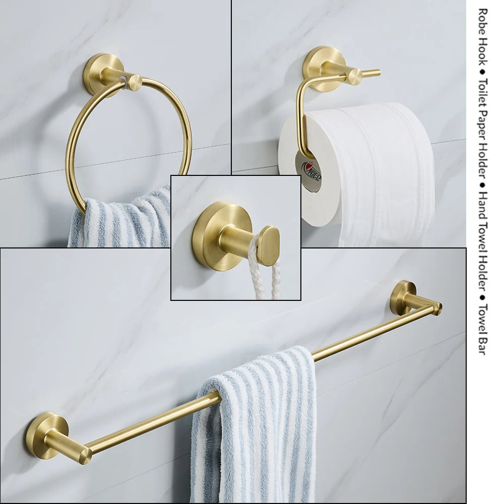 Set of gold bathroom accessories including a robe hook, toilet paper holder, hand towel holder, and towel bar on a tiled wall.