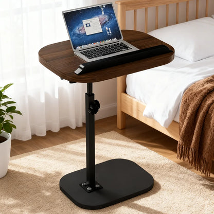 Wooden adjustable laptop desk in a bedroom setting with a laptop on top.