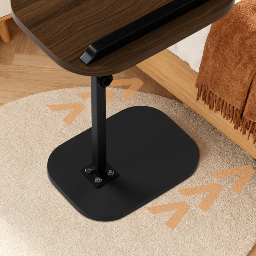 Black base of a wooden table on a beige carpet with a brown chair and rug in the background