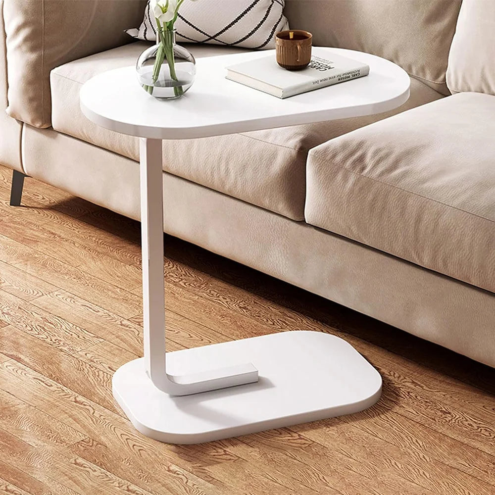 White side table with a minimalistic design in a living room setting.