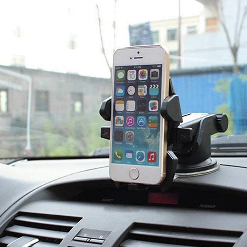 Phone mounted on a car dashboard holder with a smartphone displaying app icons.