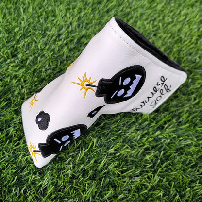 White golf club head cover with black sunglasses design on grass