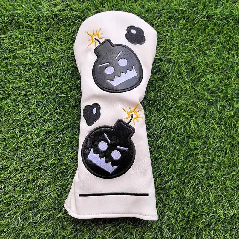Golf club head cover with cartoon bomb design on grass