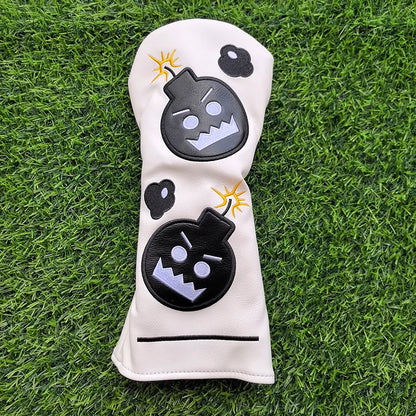 Golf club head cover with cartoon bomb design on grass
