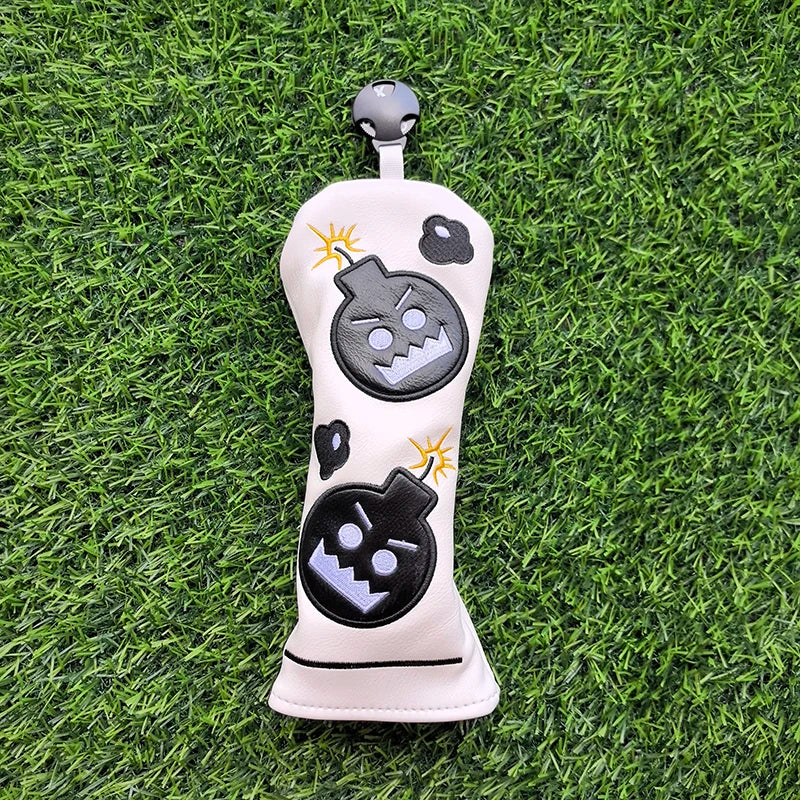 Golf club head cover with cartoon design on grass