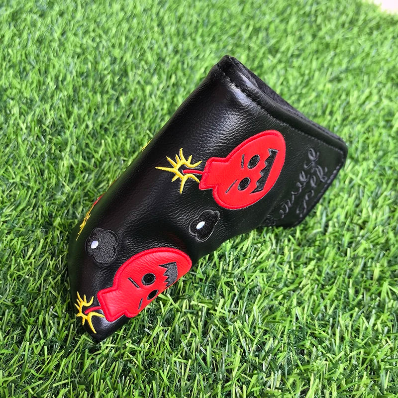 Golf club head cover with ladybug design on a grass background